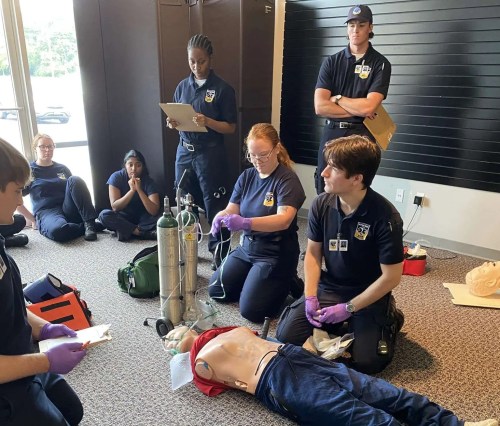 EMT student practicing with medical equipment